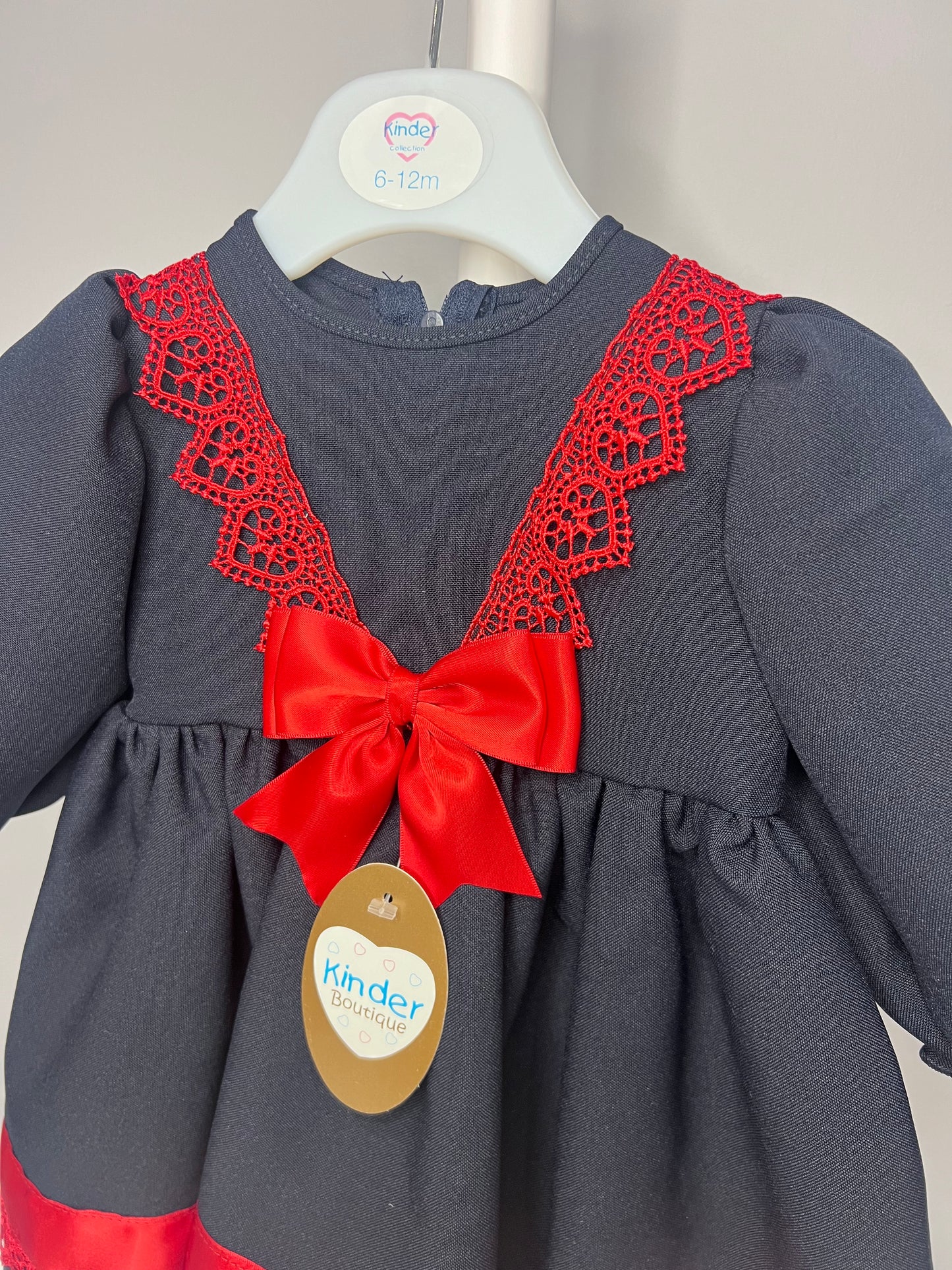 Navy Baby Girl Christmas Kinder Dress with Red Trim and Bow - Perfect for the Holiday Season